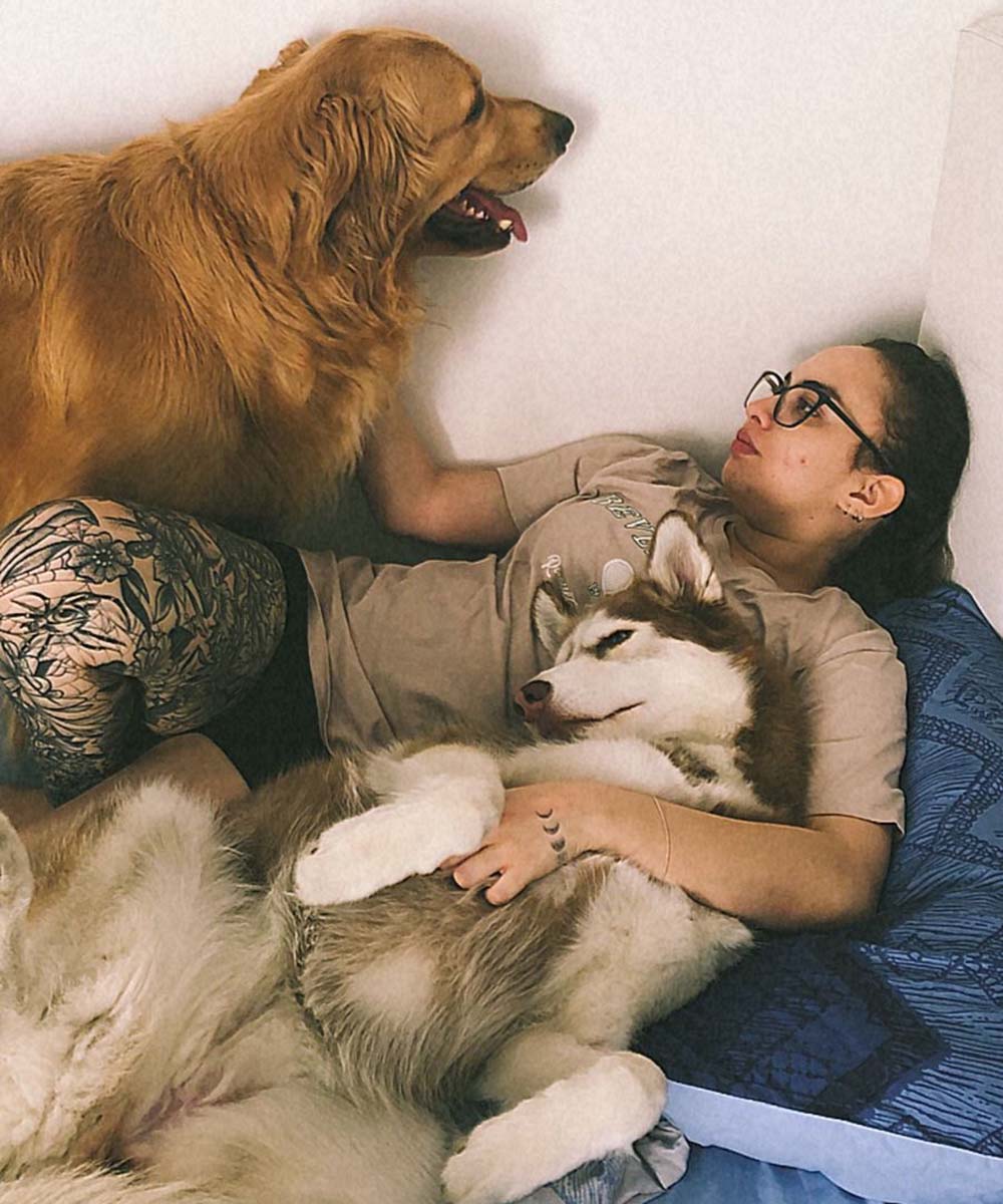 catalina cristancho laying with dogs