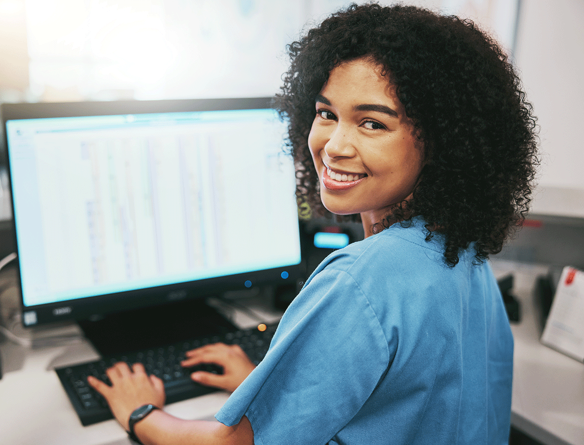 healthcare worker smiling as she evaluates data after choosing the right revenue cycle management software