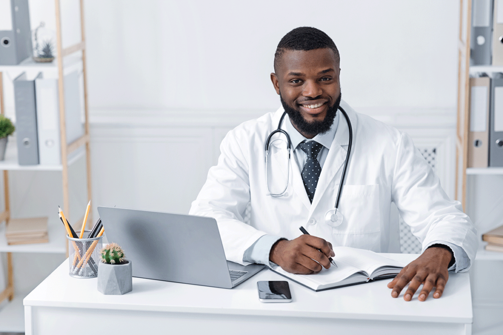 healthcare professional seated behind desk smiling as he explores how RCM ensures data security