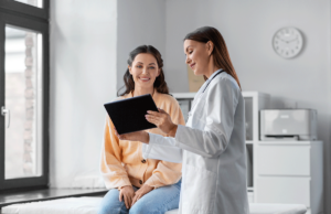 behavioral healthcare professional sharing a tablet with a client and explaining how new software can benefit your treatment center