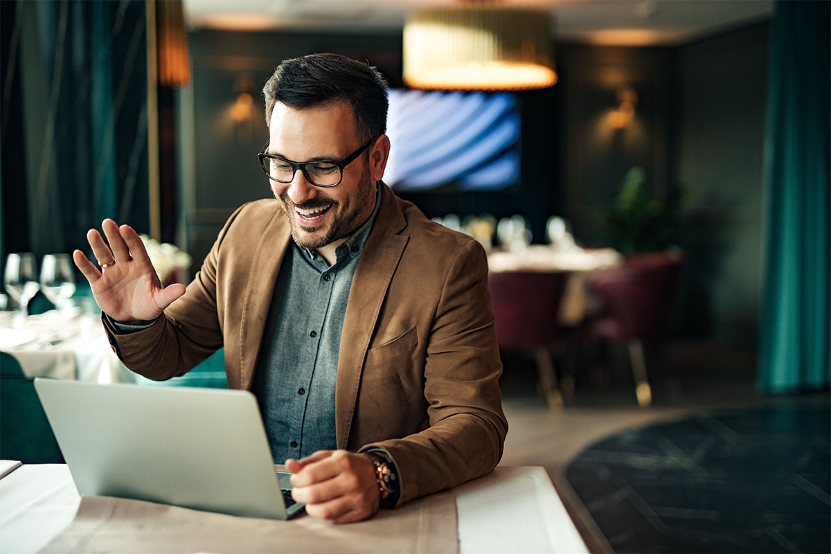 behavioral health professional as he works on a laptop seamlessly intergrating telehealth into behavioral health EMR systems