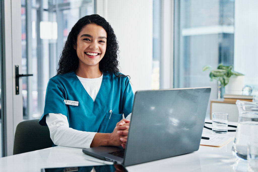 Nurse smiling on laptop