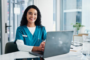 Nurse smiling on laptop